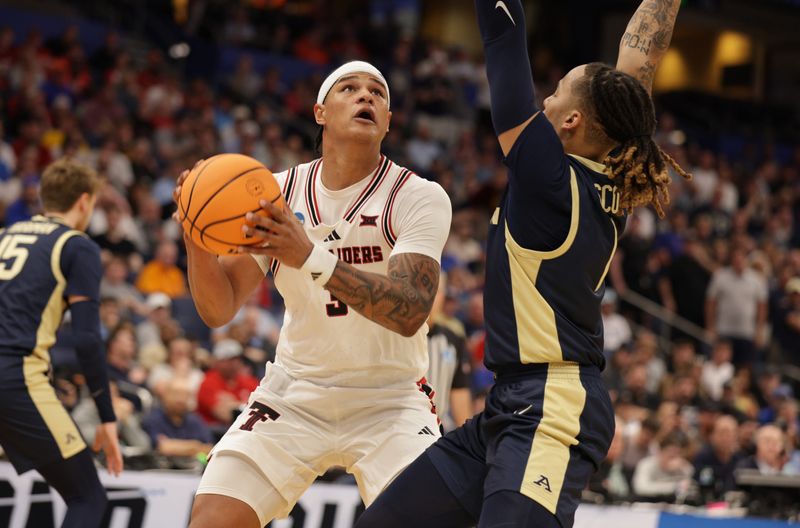 Mar 20, 2026; Tampa, FL, USA; Texas Tech Red Raiders forward Lejuan Watts (3) drives against Akron Zips guard Shammah Scott (1) in the second half during a first round game of the men's 2026 NCAA Tournament at Benchmark International Arena. Mandatory Credit: Nathan Ray Seebeck-Imagn Images