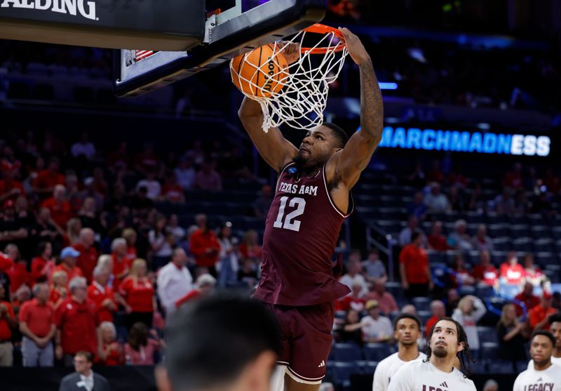 Mar 21, 2026; Oklahoma City, OK, USA; Texas A&M Aggies forward Rashaun Agee (12) dunks during the first half against the Houston Cougars in a second round game of the men's 2026 NCAA Tournament at Paycom Center. Mandatory Credit: Alonzo Adams-Imagn Images
