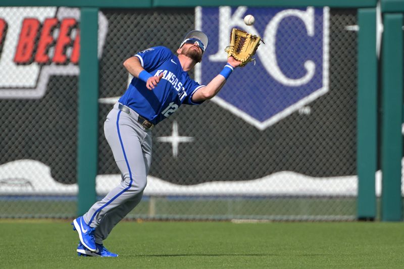 Feb 20, 2026; Surprise, Arizona, USA; Kansas City Royals left fielder Nick Loftin (12) makes a play at the fence in the fifth inning against the Texas Rangers at Surprise Stadium. Mandatory Credit: Jayne Kamin-Oncea-Imagn Images