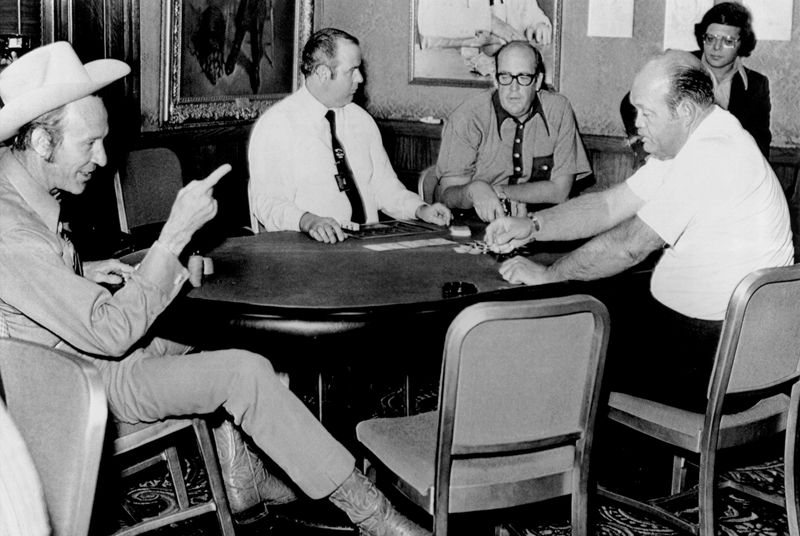 The third annual world series of poker played until dawn on May 18, 1972 in Las Vegas at the Horseshoe Casino and after a week of grim poker, only two players survived the final round: (L-R) "Amarillo Slim", Peston, Texas; the casino dealer; "Texas" Doyle, who cashed in because of fatigue, and W.C. "Puggy" Pearson, Nashville, Tennessee.
