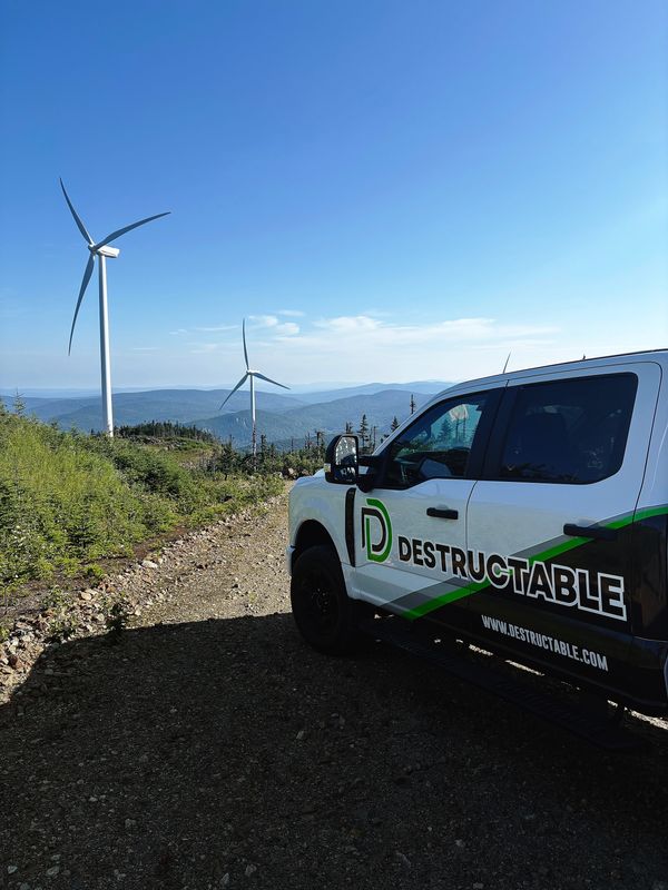 A Destructable vehicle parks along a stretch of wind turbines. The Amarillo-based company specializes in deconstructing aging wind turbines and recycling the parts.