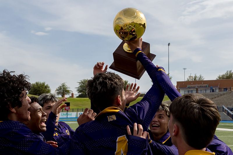 Burges players lift the trophy after a 1-0 overtime win over Fort Worth Wyatt in a Class 5A Division II regional final at Astound Broadband Stadium in Midland, Texas, on Tuesday, March 31, 2026.