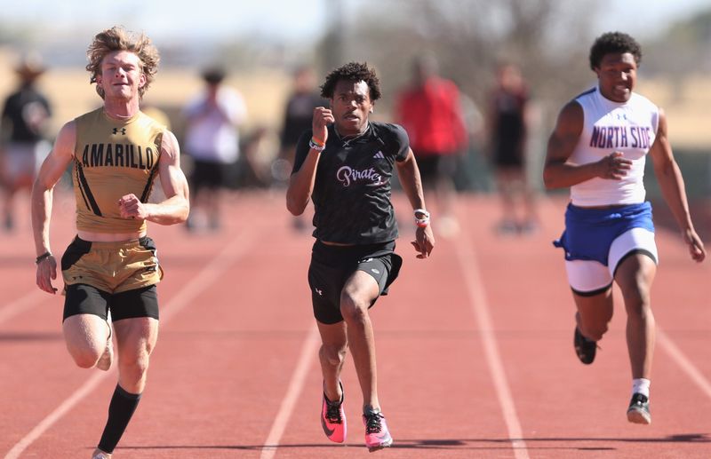 Lubbock-Cooper's Josiah Davis, center, competes in the 100 meters during the District 3-5A track and field meet Thursday, April 2, 2026, at Pirate Stadium in Woodrow.