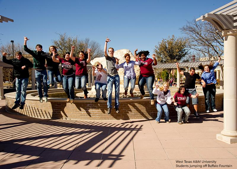 West Texas A&M University students jumping off Buffalo Fountain.