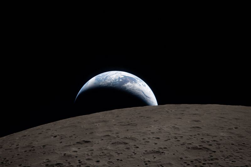 A view of Earth, partially hidden behind the moon, captured through the Orion spacecraft window on April 6, 2026, during the Artemis II mission.