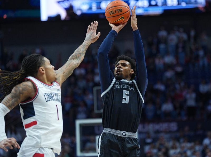 Feb 14, 2026; Storrs, Connecticut, USA; Georgetown Hoyas guard KJ Lewis (5) shoots the ball against UConn Huskies guard Solo Ball (1) in the second half at Harry A. Gampel Pavilion. Mandatory Credit: David Butler II-Imagn Images