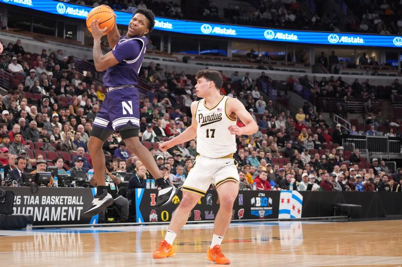 Mar 12, 2026; Chicago, IL, USA; Northwestern Wildcats guard Jayden Reid (4) grabs the ball from Purdue Boilermakers guard Omer Mayer (17) during the first half at United Center. Mandatory Credit: David Banks-Imagn Images