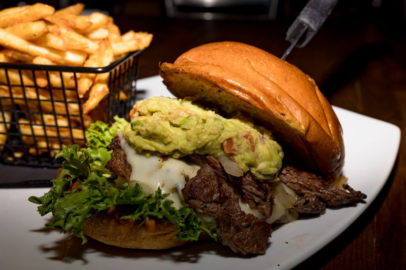 The Border Burger is prepared with arrachera, guacamole, Monterey habanero cheese, grilled onions, green leaf lettuce and tomato, served with fries, at Rockstar Burger Bar in East El Paso, Texas, on Thursday, April 9, 2026, at 13649 Eastlake Blvd C-1.