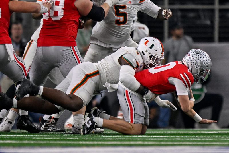 Dec 31, 2025; Arlington, TX, USA; Miami Hurricanes defensive lineman Rueben Bain Jr. (4) sacks Ohio State Buckeyes quarterback Julian Sayin (10) during the 2025 Cotton Bowl and quarterfinal game of the College Football Playoff at AT&T Stadium. Mandatory Credit: Jerome Miron-Imagn Images