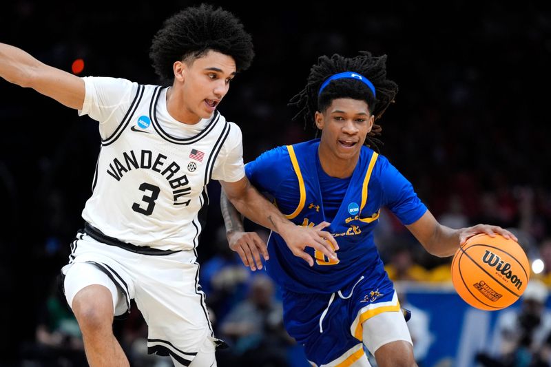 McNeese Cowboys guard Tyshawn Archie (8) dribbles beside Vanderbilt Commodores guard Tyler Tanner (3) during a first-round game in the NCAA men's basketball tournament between McNeese and Vanderbilt at Paycom Center in Oklahoma City, Thursday, March 19, 2026.
