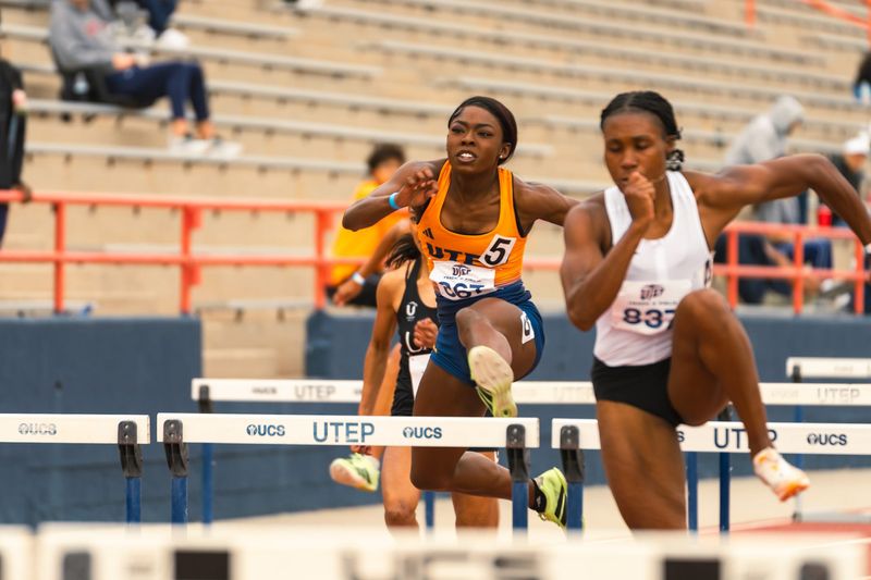 UTEP's Cyndi Martin chases alum and professional Marissa Simpson in the 100 hurdles at UTEP's Sun City Classic meet Saturday, April 11 at Kidd Field