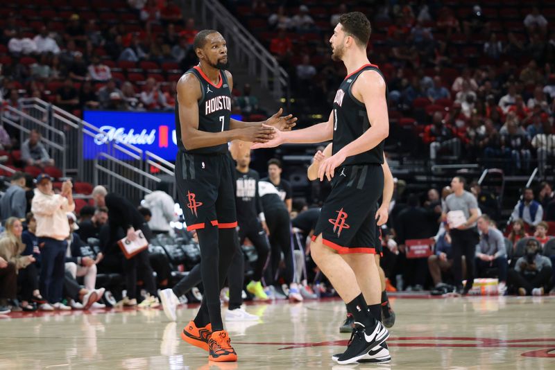 Feb 25, 2026; Houston, Texas, USA; Houston Rockets forward Kevin Durant (7) celebrates with center Alperen Sengun (28) after a play during the first quarter against the Sacramento Kings at Toyota Center. Mandatory Credit: Troy Taormina-Imagn Images