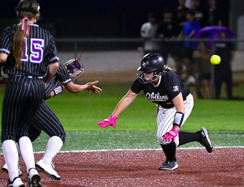 Abilene High’s Jewels Holt dives safely for second base as the Wylie infield closes in during Tuesday’s district game at Wylie High School. Final score was 18-2, Abilene High.