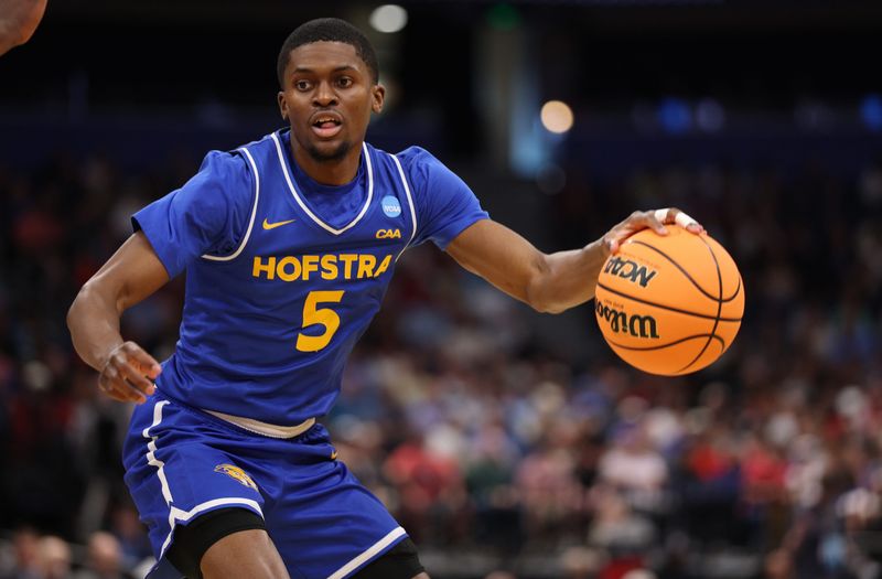 Mar 20, 2026; Tampa, FL, USA; Hofstra Pride guard Cruz Davis (5) dribbles in the second half against the Alabama Crimson Tide during a first round game of the men's 2026 NCAA Tournament at Benchmark International Arena. Mandatory Credit: Nathan Ray Seebeck-Imagn Images