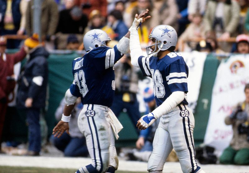 Jan 22, 1983; Washington, DC, USA; FILE PHOTO; Dallas Cowboys running back Tony Dorsett celebrates with receiver Drew Pearson during the 1982 NFC Championship Game against the Washington Redskins at RFK Stadium. Mandatory Credit: Manny Rubio-USA TODAY Sports