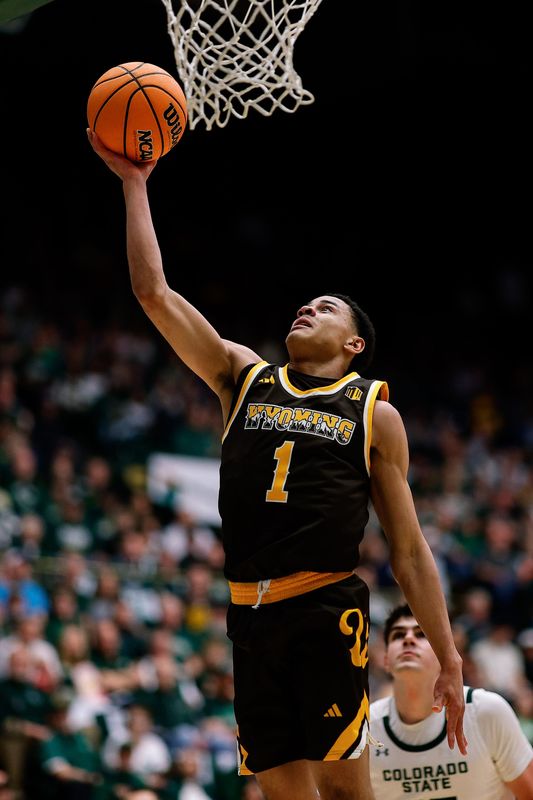 Feb 14, 2026; Fort Collins, Colorado, USA; Wyoming Cowboys guard Damarion Dennis (1) drives to the net in the first half against the Colorado State Rams at Moby Arena. Mandatory Credit: Isaiah J. Downing-Imagn Images