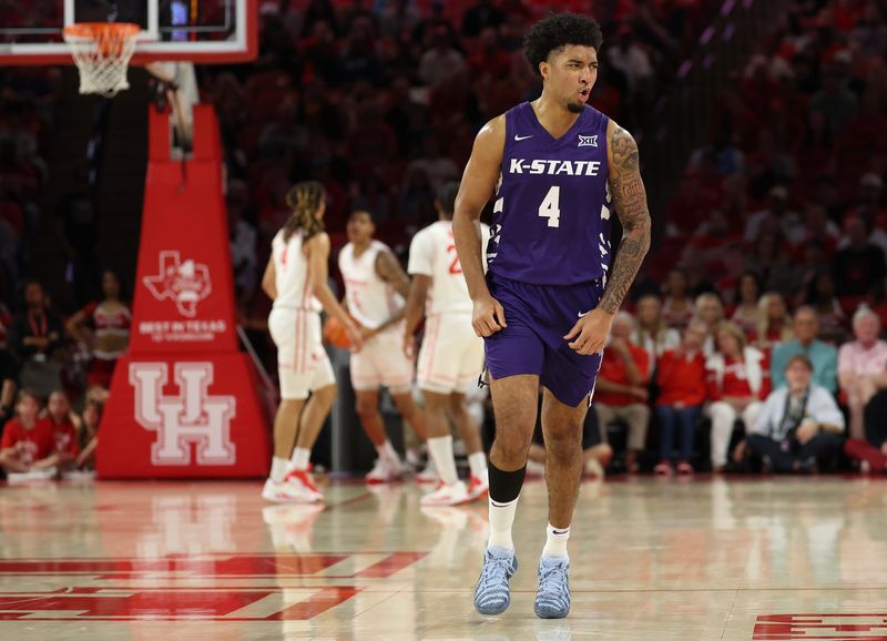 Feb 14, 2026; Houston, Texas, USA; Kansas State Wildcats guard PJ Haggerty (4) celebrates his three point basket against the Houston Cougars in the first half at Fertitta Center. Mandatory Credit: Thomas Shea-Imagn Images