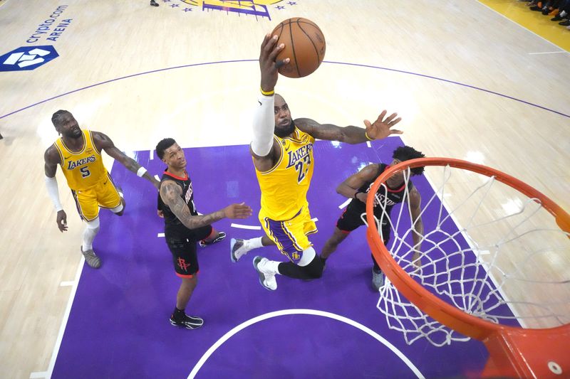 Apr 18, 2026; Los Angeles, California, USA; Los Angeles Lakers forward LeBron James (23) shoots the ball against Houston Rockets forward Jabari Smith Jr. (10) and guard Amen Thompson (1) in the second half during game one of the first round of the 2026 NBA Playoffs at Crypto.com Arena. Mandatory Credit: Kirby Lee-Imagn Images