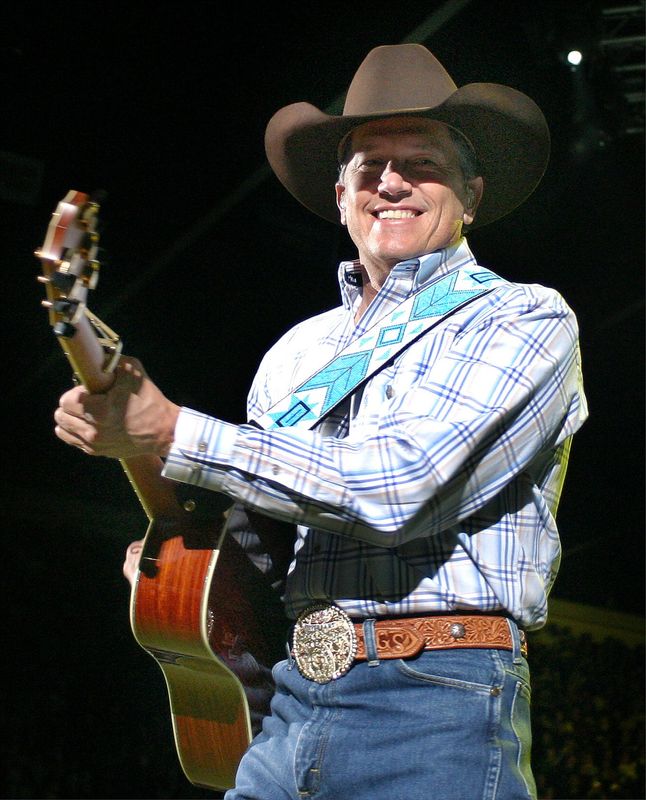 Sun-News photo by Shari Vialpando
George Strait smile at the crowd as he plays "Check Yes or No," during his set at the Pan American Center on Thursday.