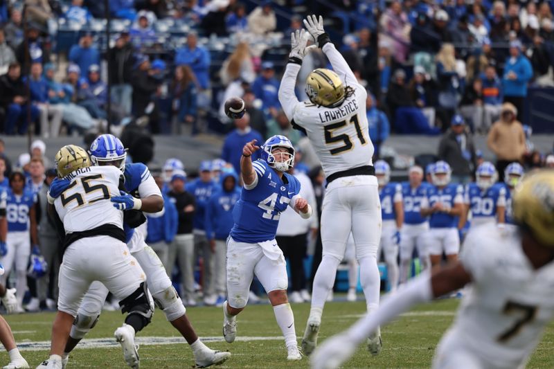 Nov 29, 2025; Provo, Utah, USA; BYU Cougars quarterback Bear Bachmeier (47) throws over the reach of UCF Knights defensive end Malachi Lawrence (51) during the second half at LaVell Edwards Stadium. Mandatory Credit: Rob Gray-Imagn Images