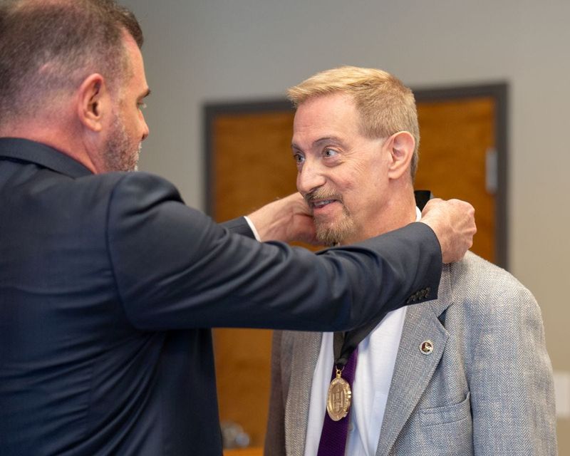 James Sernoe, the department chair and a mass communication professor, accepts the Chancellor’s Council Distinguished Teaching Award from Texas Tech University System Chancellor Brandon Creighton on April 8 at the Wichita Falls Museum of Art at MSU Texas.