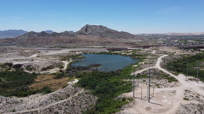 Cement Lake, also known as Portland Reservoir, is seen looking south as the El Paso Police Department closed multiple West El Paso thoroughfares Thursday amid concerns about a potential breach near Doniphan Drive. Closures include Loop 375 at Race Track Drive and Paisano Drive, Doniphan Drive between Race Track and Paisano drives, Sunland Park Drive at Crockett Street, and McNutt Road at River Levee Road while El Paso Water assesses risks and reduces water pressure at the lake.