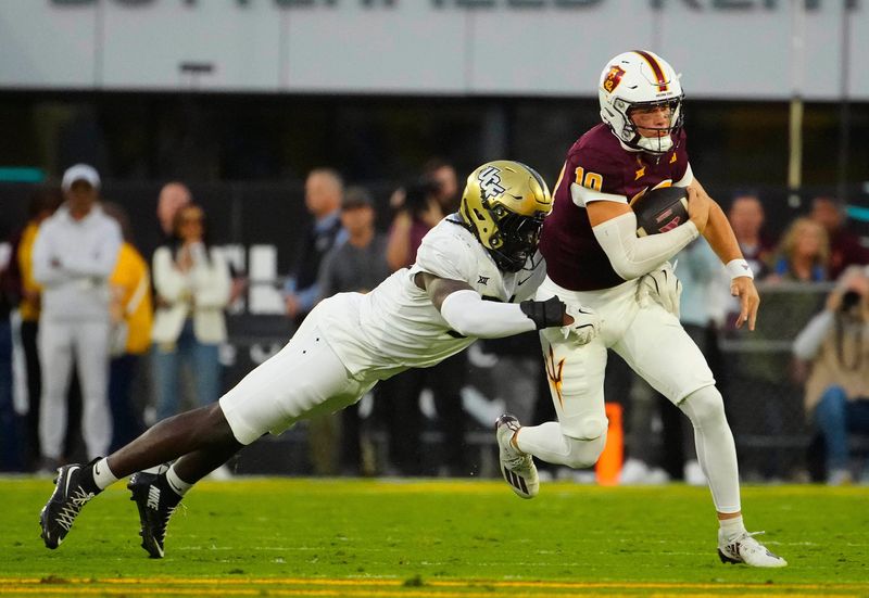 UCF defensive end Malachi Lawrence (51) tackles ASU quarterback Sam Leavitt (10) as he scrambles during a game at Mountain America Stadium in Tempe on Nov. 9, 2024.