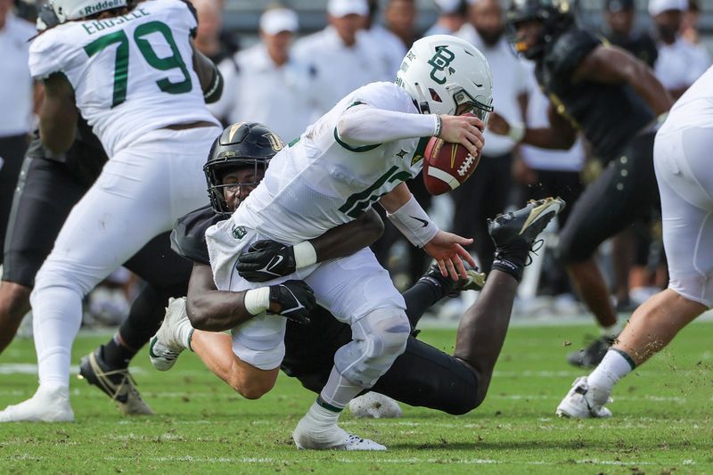 Sep 30, 2023; Orlando, Florida, USA; Baylor Bears quarterback Blake Shapen (12) is sacked by UCF Knights defensive end Malachi Lawrence (51) during the first quarter at FBC Mortgage Stadium. Mandatory Credit: Mike Watters-USA TODAY Sports
