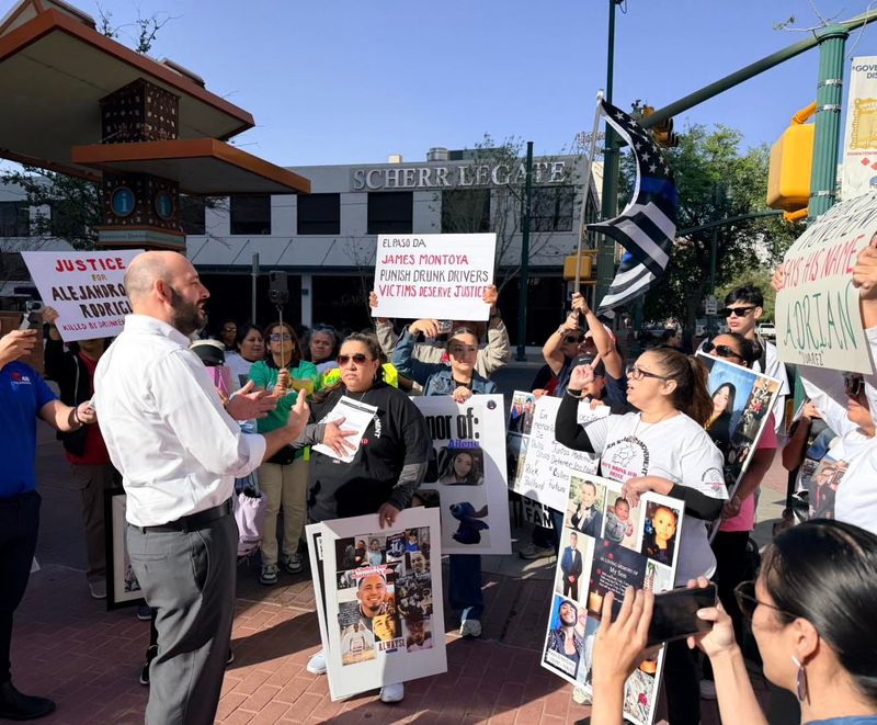 El Paso District Attorney James Montoya, left, talks to protesters outside the Enrique Moreno County Courthouse in Downtown El Paso.