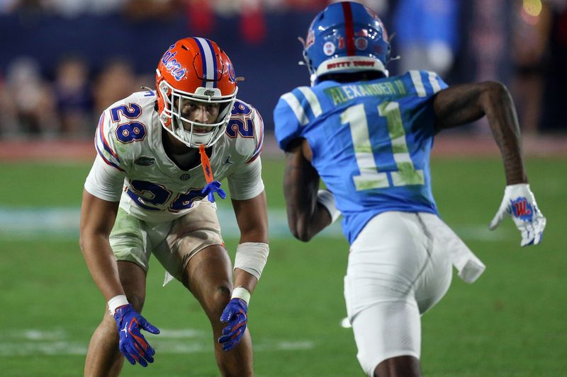 Nov 15, 2025; Oxford, Mississippi, USA; Florida Gators defensive back Devin Moore (28) defends in coverage Mississippi Rebels wide receiver Deuce Alexander (11) during the third quarter at Vaught-Hemingway Stadium. Mandatory Credit: Petre Thomas-Imagn Images