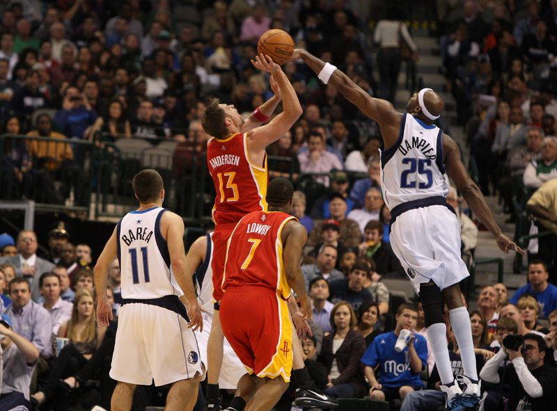 Dec 18, 2009; Dallas, TX, USA; Dallas Mavericks center Erick Dampier (25) blocks a shot from Houston Rockets center David Andersen (13) in the second quarter at American Airlines Arena. Mandatory Credit: Photo By Matthew Emmons-USA TODAY Sports
