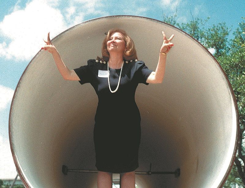 In this April 11, 1997, archive photo, then-Corpus Christi Mayor Mary Rhodes is shown flashing two "victory" signs from inside a pipe in the parking lot of the Bayfront Plaza Convention Center.