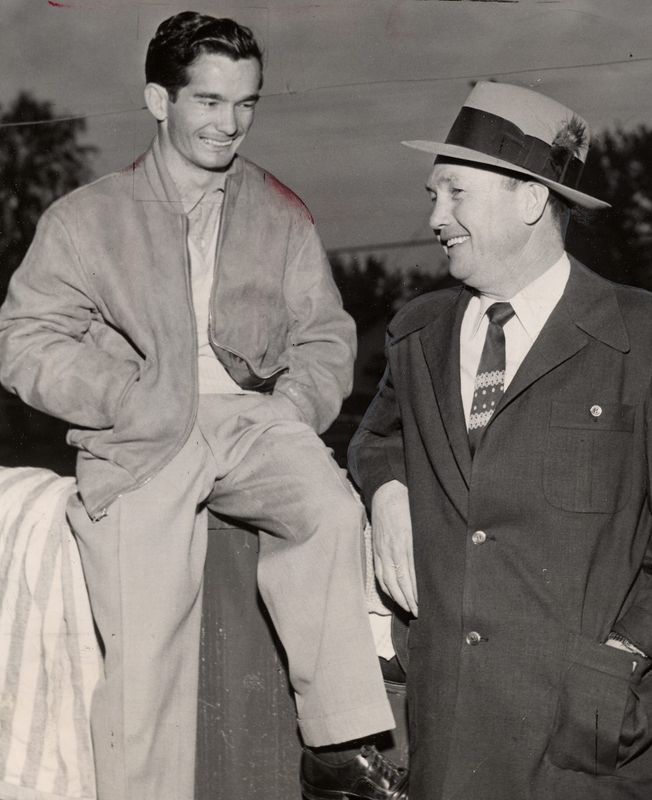 On hand for his third straight try at victory in the Kentucky Derby, jockey Willie Shoemaker, left, chats with trainer Noble Threewitt on April 29, 1954.