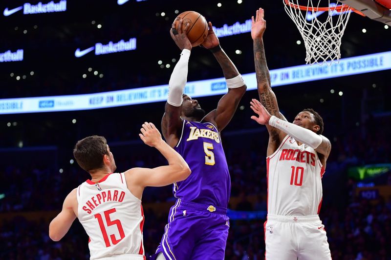 Apr 29, 2026; Los Angeles, California, USA; Los Angeles Lakers center Deandre Ayton (5) moves to the basket against Houston Rockets guard Reed Sheppard (15) and forward Jabari Smith Jr. (10) during the first half in game five of the first round of the 2026 NBA Playoffs at Crypto.com Arena. Mandatory Credit: Gary A. Vasquez-Imagn Images