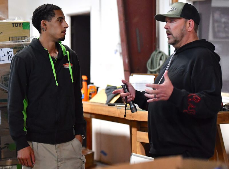Travis Haggard (right), the executive director for the Burkburnett Development Corporation, talks with Ezra Bynum, a team lead at Servpro inside the Wheels of Wonder Museum warehouse in Burkburnett on Friday, May 1, 2026. The building sustained hail and water damage after a severe thunderstorm moved through the area on Sunday, April 26, 2026, delaying the museum's open house.