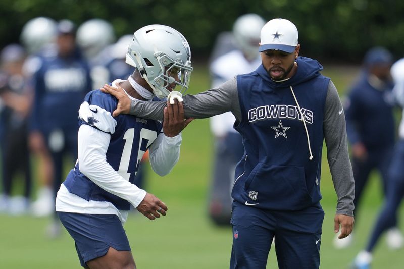 May 1, 2026; Frisco, TX, USA; Dallas Cowboys cornerback Caleb Downs (18) is coached through a drill with defensive coordinator Christian Parker at the Ford Center at the Star Training Facility in Frisco, Texas. Mandatory Credit: Chris Jones-Imagn Images