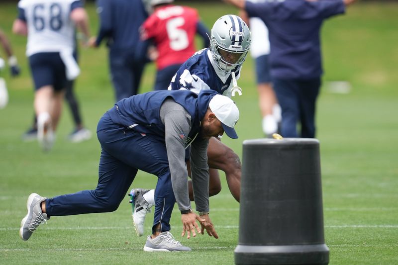May 1, 2026; Frisco, TX, USA; Dallas Cowboys cornerback Caleb Downs (18) is coached through a drill with defensive coordinator Christian Parker at the Ford Center at the Star Training Facility in Frisco, Texas. Mandatory Credit: Chris Jones-Imagn Images