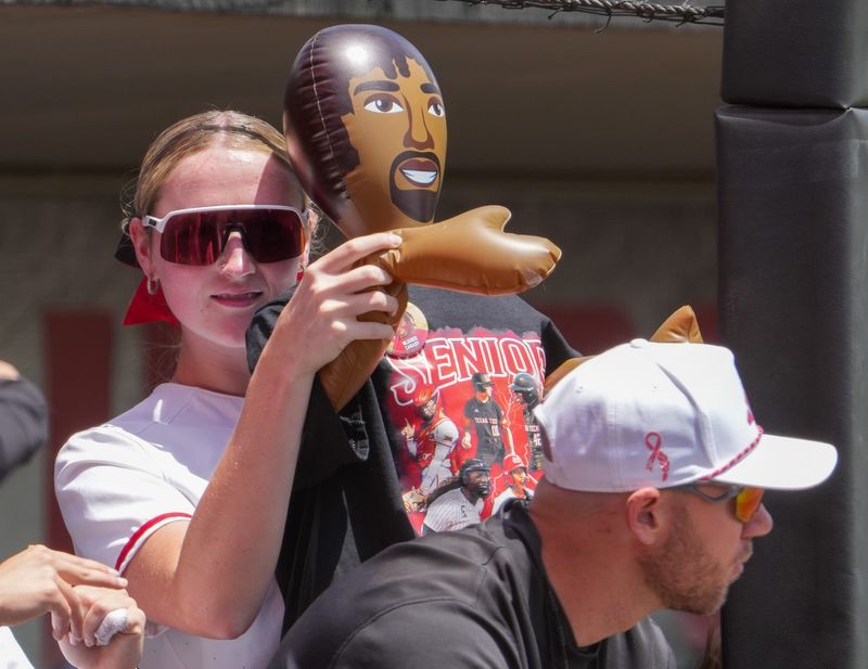 Texas Tech's Samantha Lincoln holds an inflatable man that's wear a senior day shirt in the dugout during a Big 12 Conference softball game, Saturday, May 2, 226, at Tracy Sellers Field.