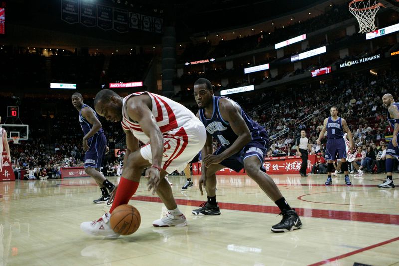 Feb 16, 2010; Houston, TX, USA; Houston Rockets forward Carl Landry (14) is defended by Utah Jazz forward Paul Millsap (24) in the second quarter at the Toyota Center. Mandatory Credit: Brett Davis-USA TODAY Sports