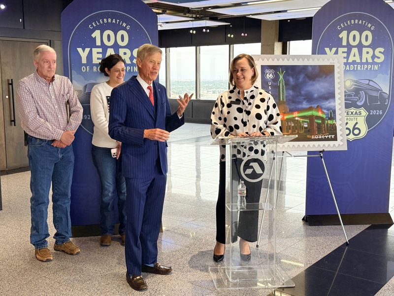 At a May 6 celebration, Richard Ware, left, with Kashion Smith, Visit Amarillo Executive Director, announces a new USPS Forever Stamp honoring the famous U-Drop Inn located in Shamrock. Standing in the back row are Shamrock City Manager Troy Potts and Lianne Halpern with the U-Drop Inn. The iconic, green art deco cafe has served the public for decades along Route 66.