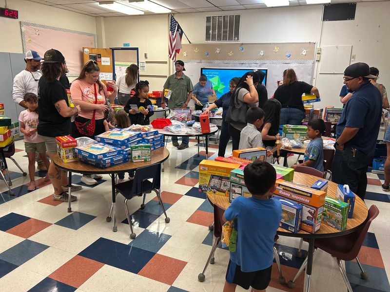 Sanders Elementary School offers educational materials for families to take home on May 7 ahead of its closure.