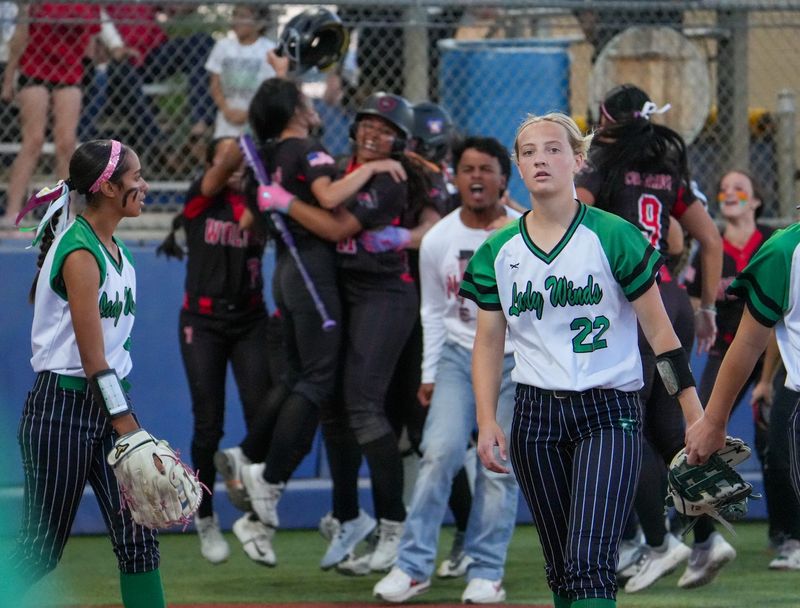 Floydada players walk off the field as Colorado City celebrates its 7-6 walk-off win in a Region I-2A Division I regional semifinal softball game, Thursday, May 7, 2026, at Frenship High School in Wolfforth.