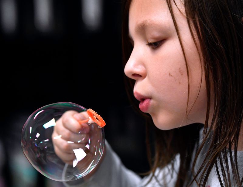 Ramsay Euton, a first grade student, uses a more traditional wand to make her bubble during the Bubble Project Student Showcase for parents May 7. Bowie kindergarten through second grade students have been learning about fluid dynamics and materials science by exploring various wand designs for making soap bubbles. In the fall, Bowie and Purcell elementary schools both will become elementary STEM campuses for kindergarten-fifth grade.