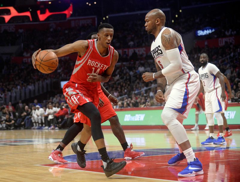 April 10, 2017; Los Angeles, CA, USA; Houston Rockets forward Troy Williams (14) moves the ball against Los Angeles Clippers center Marreese Speights (5) during the first half at Staples Center. Mandatory Credit: Gary A. Vasquez-USA TODAY Sports
