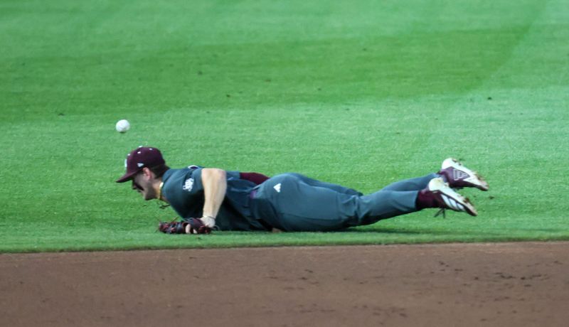 A infield hit gets by Texas A&M infielder Boston Kellner (6) during an NCAA baseball game at Condron Family Ballpark at Alfred A. McKethan Field in Gainesville, FL on Friday, April 24, 2026. [Alan Youngblood/Gainesville Sun]