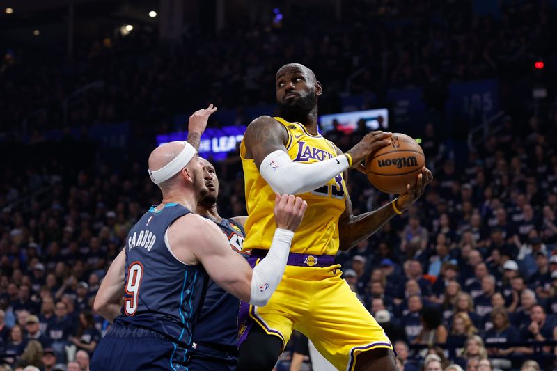 May 7, 2026; Oklahoma City, Oklahoma, USA; Los Angeles Lakers forward LeBron James (23) looks to pass as Oklahoma City Thunder guard Alex Caruso (9) defends in the first half during game two of the second round of the 2026 NBA Playoffs at Paycom Center. Mandatory Credit: Alonzo Adams-Imagn Images