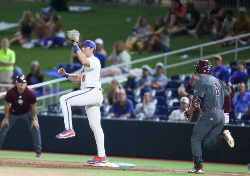 Florida infielder Ethan Surowiec (10) tags out Texas A&M infielder Boston Kellner (6) at first during an NCAA baseball game at Condron Family Ballpark at Alfred A. McKethan Field in Gainesville, FL on Friday, April 24, 2026. [Alan Youngblood/Gainesville Sun]