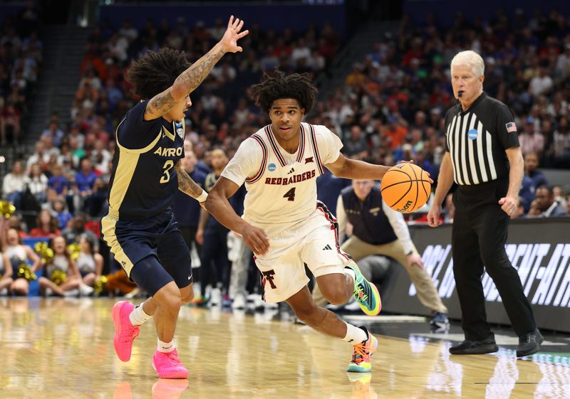 Mar 20, 2026; Tampa, FL, USA; Texas Tech Red Raiders guard Christian Anderson (4) drives against Akron Zips guard Sharron Young (3) in the second half during a first round game of the men's 2026 NCAA Tournament at Benchmark International Arena. Mandatory Credit: Nathan Ray Seebeck-Imagn Images