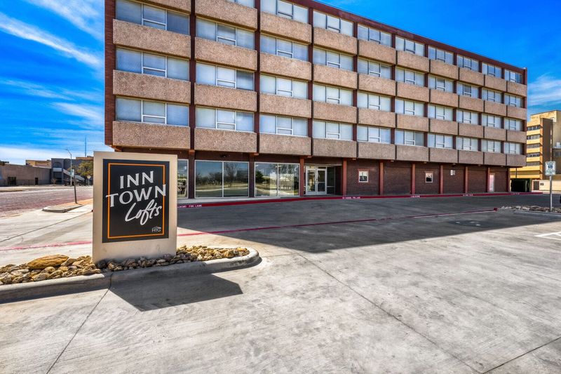 The north elevation of the historic Inn Town Lofts, 1202 Main St., looking south shows the monument sign and main historic pedestrian entrance from the parking lot in Lubbock, Texas.