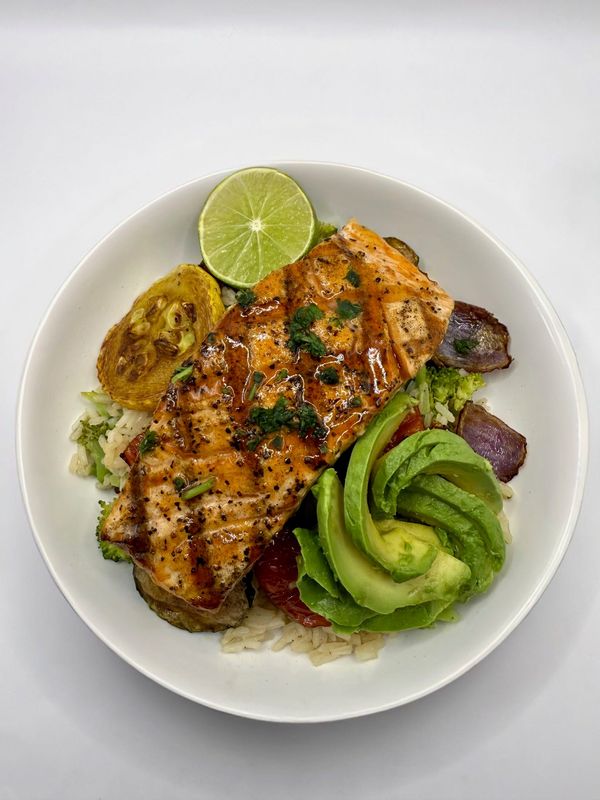 The Sheriff's Power Bowl features honey chipotle grilled salmon on a bed of steamed white rice with grilled vegetables, lime garnish and sliced avocado. It is one of the dishes available at Outlaws, 4525 Milwaukee Ave., Suite 600, in Lubbock, Texas.